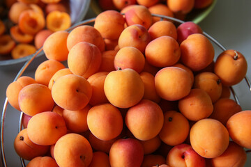 Ripe, juicy apricots in bowls, preparation of apricots for jam