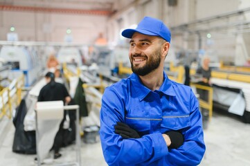 Smiling factory worker with crossed arms in pvc and aluminum window factory
