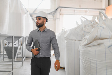 Food engineer inspecting production in a flour mill