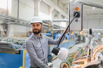 Industrial engineer operating machinery in modern factory