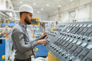 Industrial engineer operating machinery in modern factory