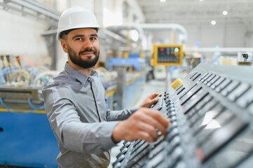 Engineer operating machinery in modern industrial factory