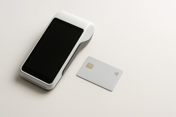 Modern wireless POS terminal with blank light gray credit card on soft neutral background minimal payment technology concept with copy space