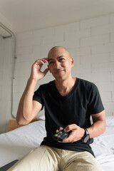 Man watching television looking sad and stressed with headache