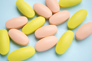 Colorful medicine pills tablet on blue background
