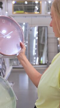 Customer Choosing Wall Clock in Home Goods Store