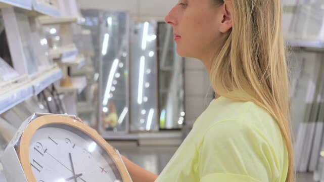 Customer Choosing Wall Clock in Home Goods Store