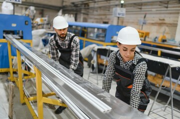 Factory workers manufacturing pvc windows and doors