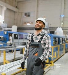 Factory worker laughing in pvc and aluminum window and door production plant