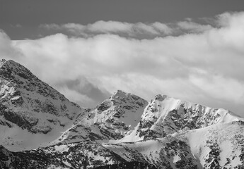 High rock peaks covered with snow in the High Tatras, high-altitude hiking trails, Polish mountains