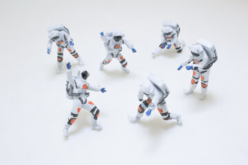 Fototapeta premium Group of Miniature Astronaut Figures in Space Exploration Suits