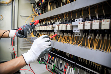 Electrician use meters to measure current at devices in the MDB cabinet, for safety in the...