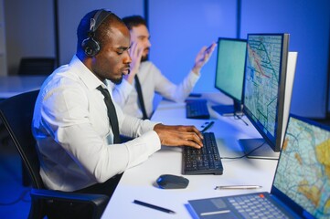 Center of dispatching maintenance. Waist up side on of young afro american male working on air...