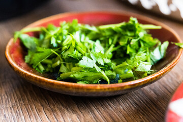Parsley, chopped, ready to be added to the dish.
