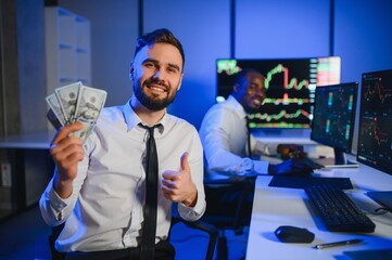 Holding Dollar bills in the stock market. Investor counting money after making it big on the stock market