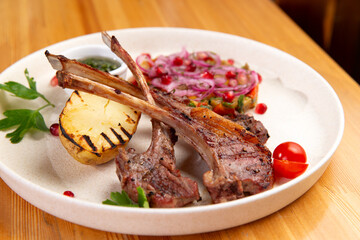 Roasted racks of lamb. On a wooden table.