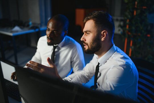 Team of traders working with forex trading charts and graphs on computer screen