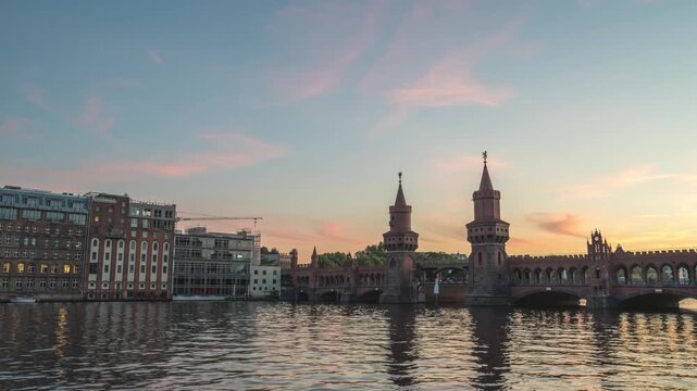Berlin Germany time lapse, day to night sunset city skyline at Oberbaum Bridge and Spree River