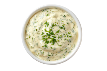 Creamy, light yellow sauce in a small white bowl, topped with fresh dill