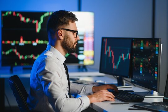 Crypto trader investor analyst looking at computer screen analyzing financial graph data on monitor