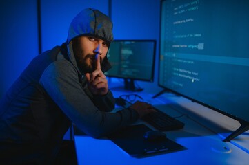Hacker Using Multiple Computers For Stealing Data On Desk