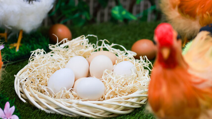 Close-up of eggs in a straw nest with decorative spring details, symbolizing Easter, new life and rural tradition