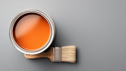 White paint can with orange paint and brush on light gray background, right-side layout with large left copy space