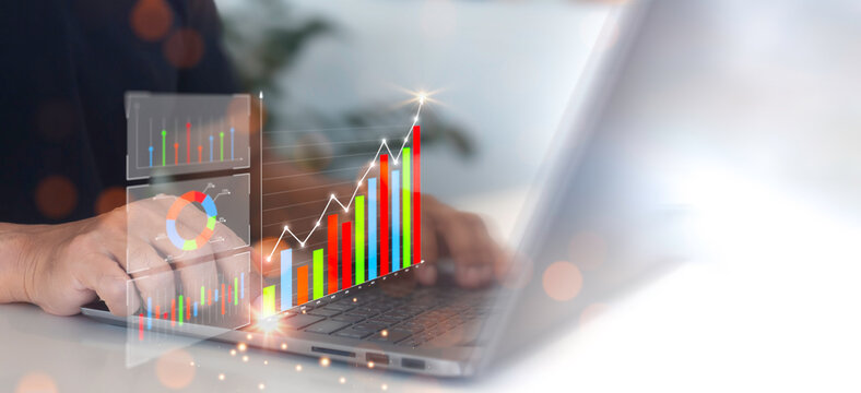 Businessman analyzing economic growth chart on virtual screen for business finance and financial decision making, strategy, data collection, forecasting, financial concept and business investment.