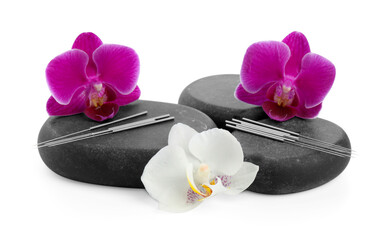 Acupuncture needles, orchid flowers and spa stones isolated on white