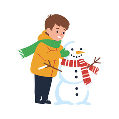 Boy in winter clothes building a snowman with carrot nose and striped scarf.