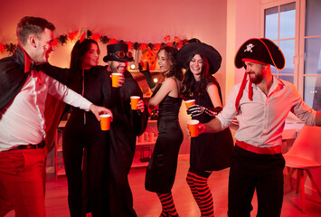 Happy Halloween dancing holiday celebration friends group fun, team wearing costumes for dress ups party night event, playing spooky horror cosplay, garland red light atmosphere, ghostly decoration