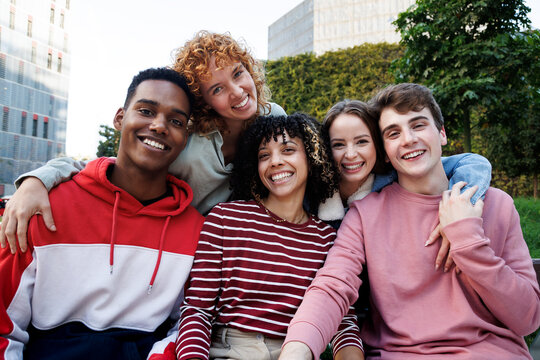 Happy diverse students embracing each other in a university campus