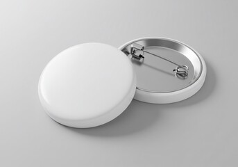 Two Blank White Round Buttons with Metal Backs on a Gray Surface