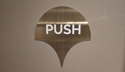 Push symbol written on the door. Golden curved sign with white 