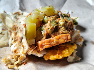 Nasi pecel or sego pecel is a typical Javanese Indonesian rice dish served with pecel sauce, which...
