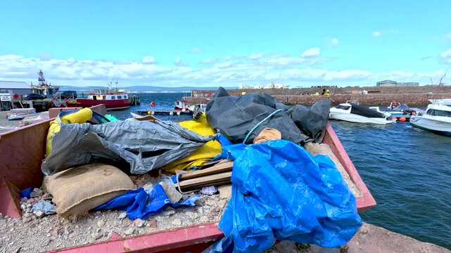 Plastic and Cloth Sacks on Cromarty Pier Overlooking Harbor