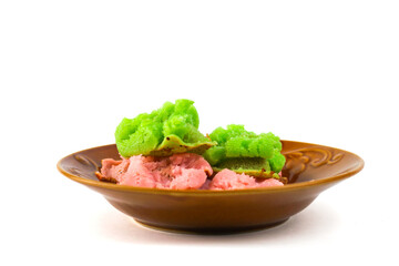 Delicious traditional Indonesian colorful carabikang served in a brown plate, isolated on a white background.