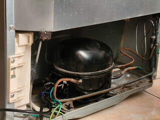Close-up of Refrigerator Compressor and Wiring.