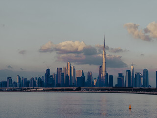 panorama view of Dubai Downtown skyline with creek harbor view at sunrise 