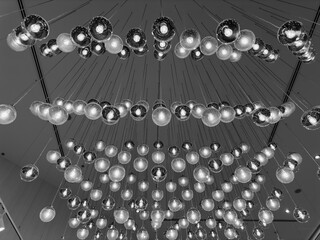 Obraz premium crystal chandelier hanging from a ceiling, black and white interior photography