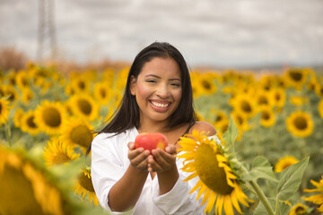 Young, attractive, Latina brunette woman wearing a white shirt, smiling happily and holding up an...