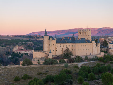 Aerial view of the Alc&Atilde;&iexcl;zar castle standing majestically against the soft dawn sky, a fortress of history and architectural prowess, Segovia, Castilla y Le&Atilde;&sup3;n, Spain.