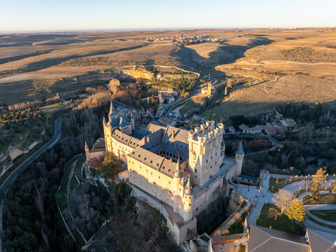 Aerial view of the Alc&Atilde;&iexcl;zar of Segovia standing majestically against the golden hues of the setting sun, a medieval fortress of stone and history, Segovia, Castilla y Le&Atilde;&sup3;n, Spain.