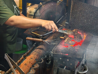 Chef Grilling Steak Over Hot Coals.