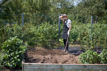Woman working in a small garden 