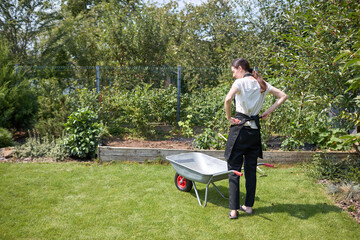 Woman working in a small garden 