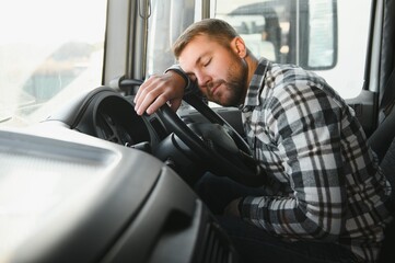 Exhausted truck driver falling asleep on steering wheel. Tiredness and sleeping concept