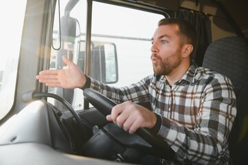 An angry truck driver is driving a truck and is annoyed with people who disturb the traffic