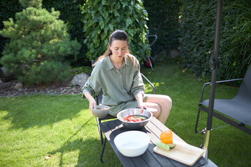 Woman cooking in her backyard