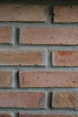 Old red brick wall background with rough textured surface